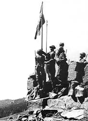 Indian troops raising the flag after the capture of the Haji Pir Pass
